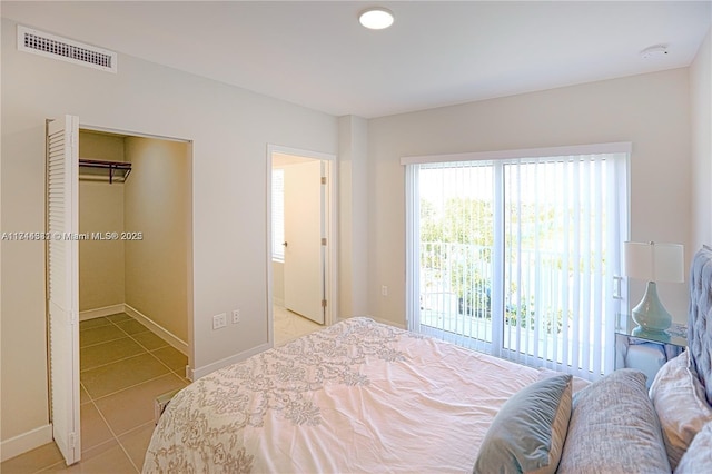 bedroom featuring light tile patterned flooring and access to exterior