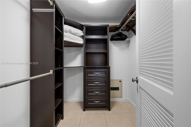 spacious closet with light tile patterned floors