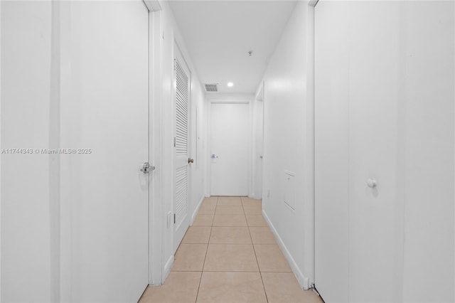 hallway featuring light tile patterned floors