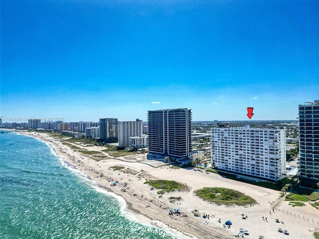 birds eye view of property with a water view, a beach view, and a city view