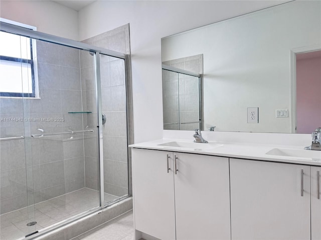 bathroom with vanity and a shower with shower door