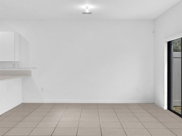 empty room with light tile patterned floors