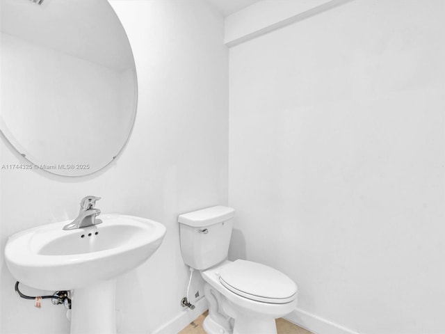 bathroom featuring sink and toilet