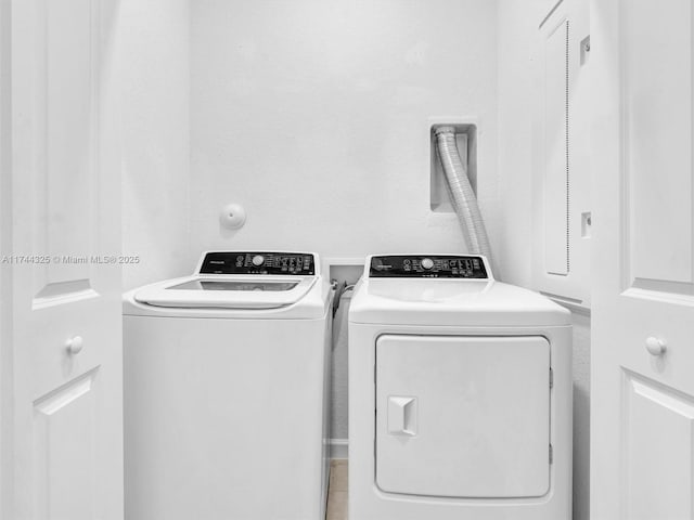 clothes washing area featuring washer and dryer