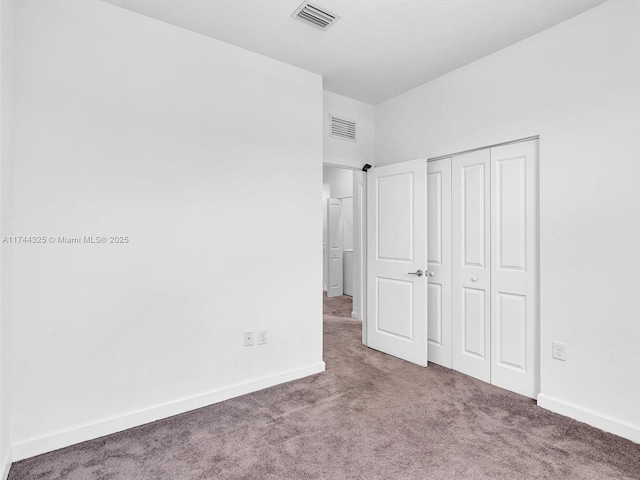 unfurnished bedroom with a closet and carpet flooring