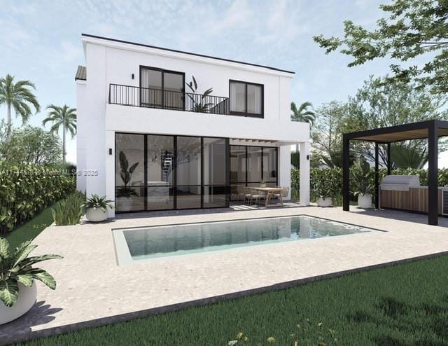 back of property featuring stucco siding, an outdoor pool, a patio, and a balcony
