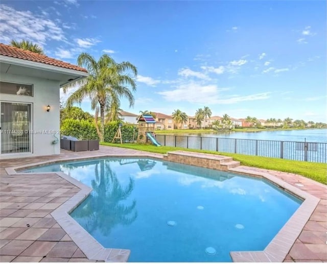 view of swimming pool with a water view, a playground, and a patio