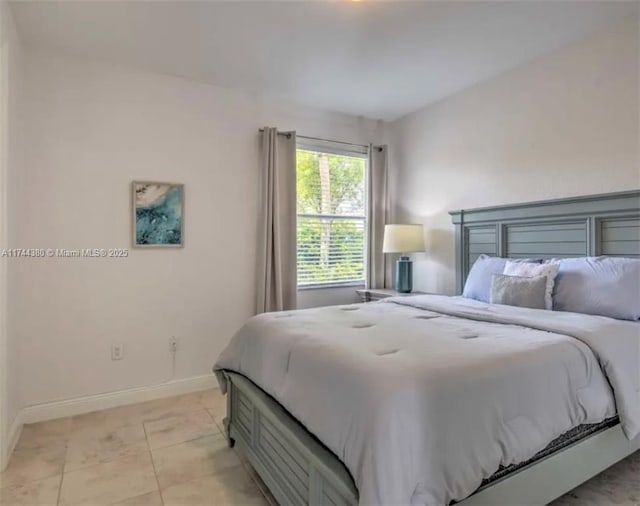 bedroom with light tile patterned floors