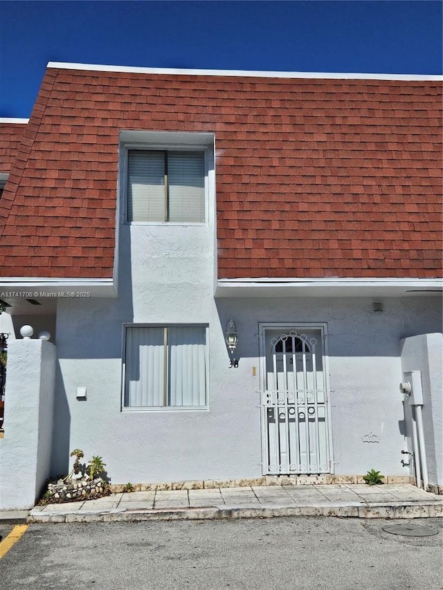 10800 NW 7th St Unit 3B, Miami, FL 33172 - exterior space featuring roof with shingles and stucco siding
