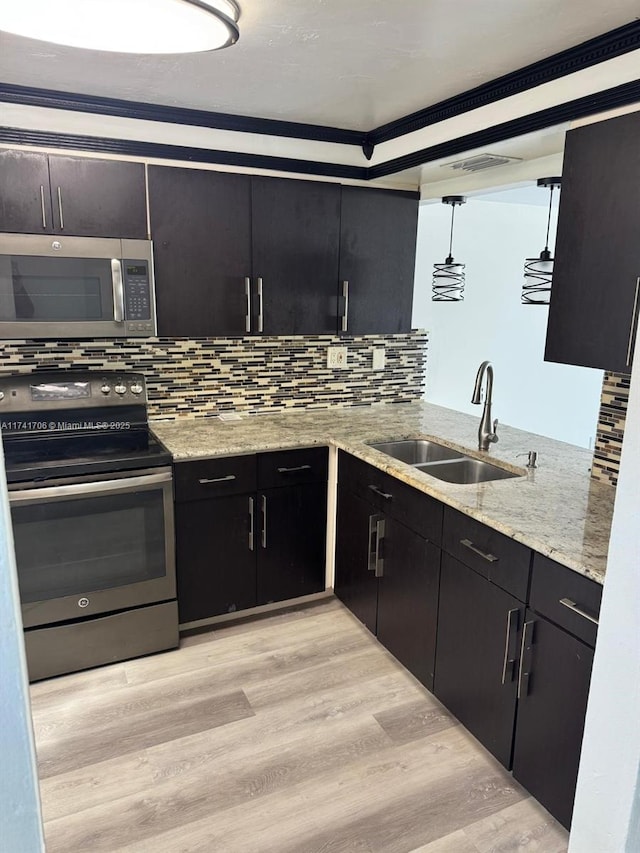 10800 NW 7th St Unit 3B, Miami, FL 33172 - kitchen with light wood finished floors, appliances with stainless steel finishes, decorative backsplash, and a sink