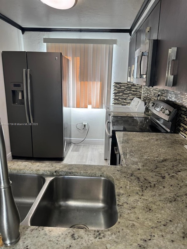 10800 NW 7th St Unit 3B, Miami, FL 33172 - kitchen featuring tasteful backsplash, baseboards, light wood-style floors, crown molding, and appliances with stainless steel finishes