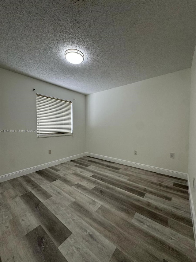 10800 NW 7th St Unit 3B, Miami, FL 33172 - unfurnished room with baseboards, wood finished floors, and a textured ceiling