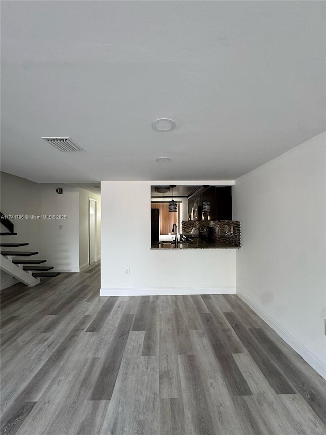 10800 NW 7th St Unit 3B, Miami, FL 33172 - unfurnished living room with visible vents, baseboards, dark wood-style flooring, and a sink