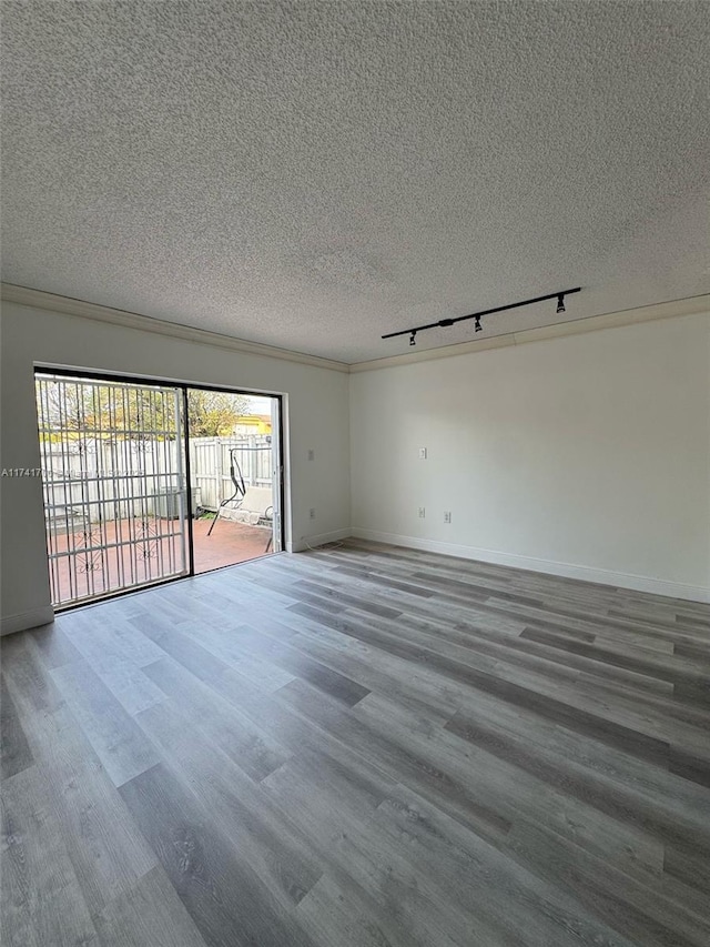 10800 NW 7th St Unit 3B, Miami, FL 33172 - spare room featuring track lighting, wood finished floors, a textured ceiling, and baseboards