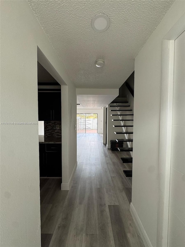 10800 NW 7th St Unit 3B, Miami, FL 33172 - hall featuring wood finished floors, a textured ceiling, baseboards, and stairway