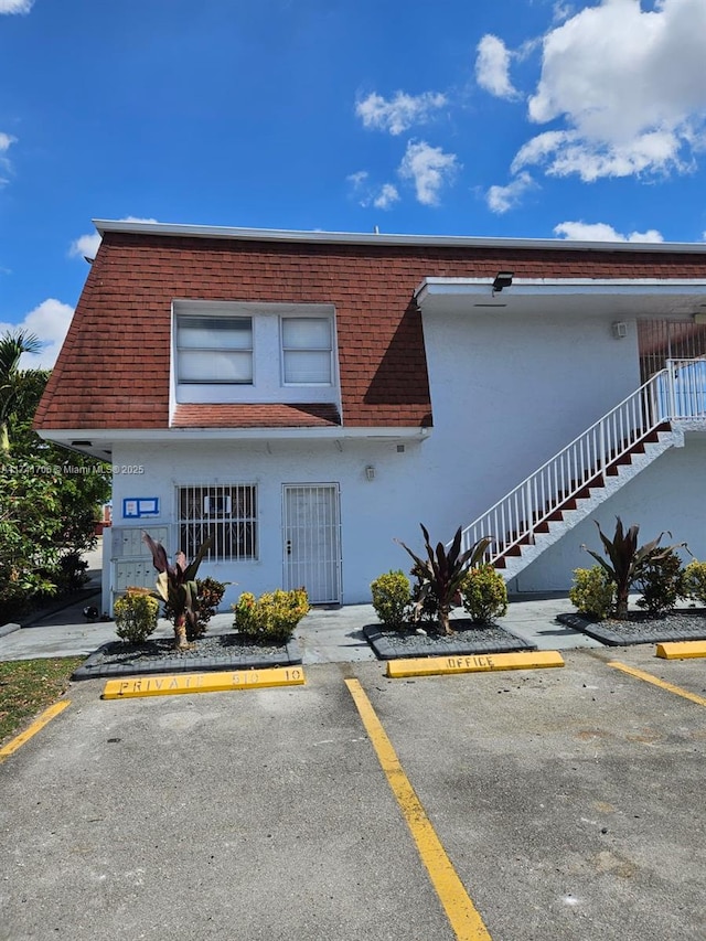 10800 NW 7th St Unit 3B, Miami, FL 33172 - view of building exterior featuring uncovered parking and stairs