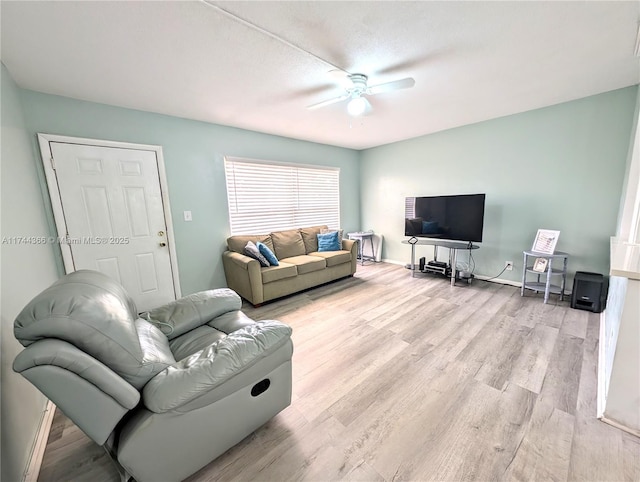 living room with ceiling fan and light wood-type flooring