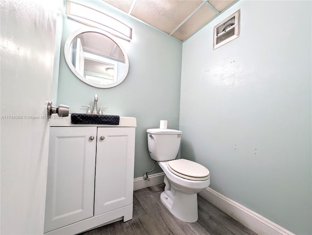 bathroom featuring vanity, toilet, and wood-type flooring