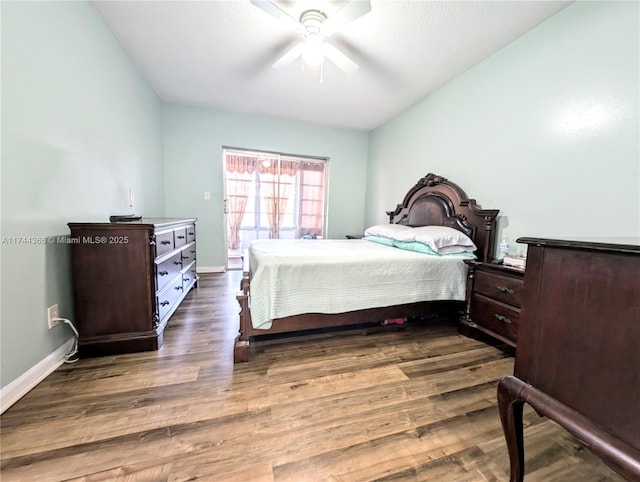 bedroom with ceiling fan and dark hardwood / wood-style flooring