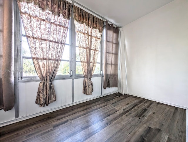 unfurnished room featuring dark hardwood / wood-style floors