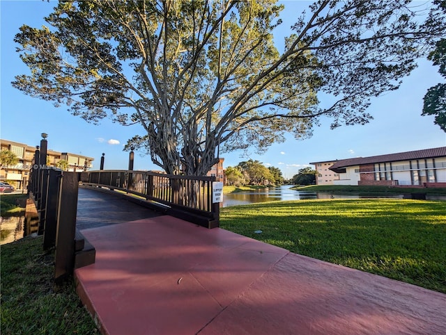 exterior space with a water view and a lawn