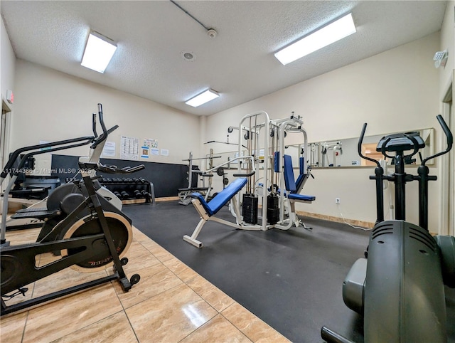 exercise room featuring a textured ceiling