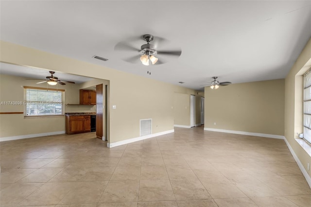 unfurnished living room featuring ceiling fan and light tile patterned flooring