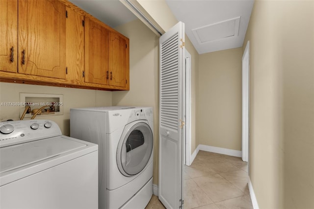 laundry area with cabinets, light tile patterned flooring, and separate washer and dryer