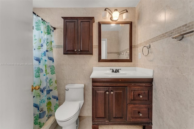 bathroom featuring vanity, toilet, a shower with shower curtain, and tile walls