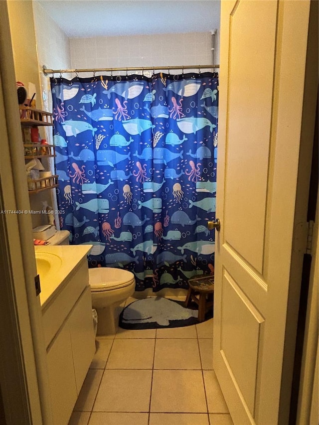 bathroom featuring vanity, tile patterned floors, and toilet