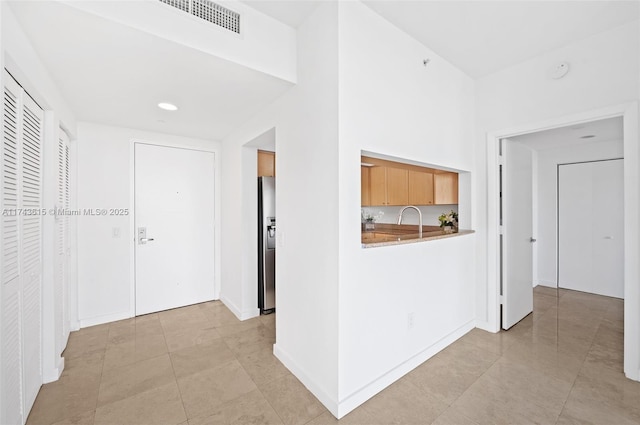 corridor with visible vents and a sink