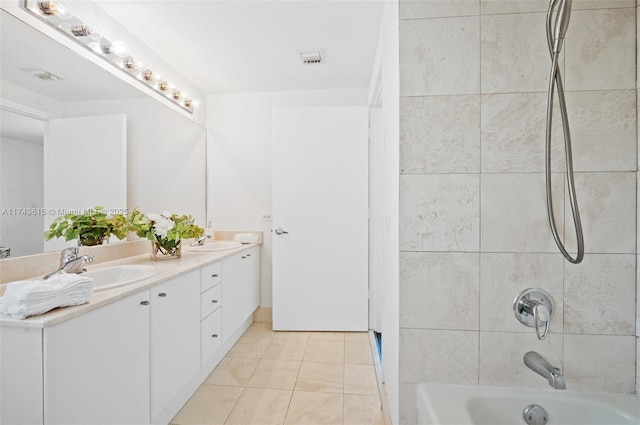 full bath with tile patterned flooring, a sink, visible vents, bathing tub / shower combination, and double vanity