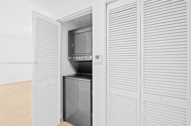 laundry area featuring laundry area and stacked washer / dryer