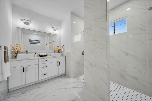 bathroom with vanity and a tile shower