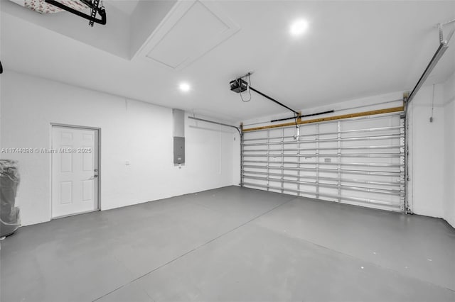 garage with a garage door opener and electric panel