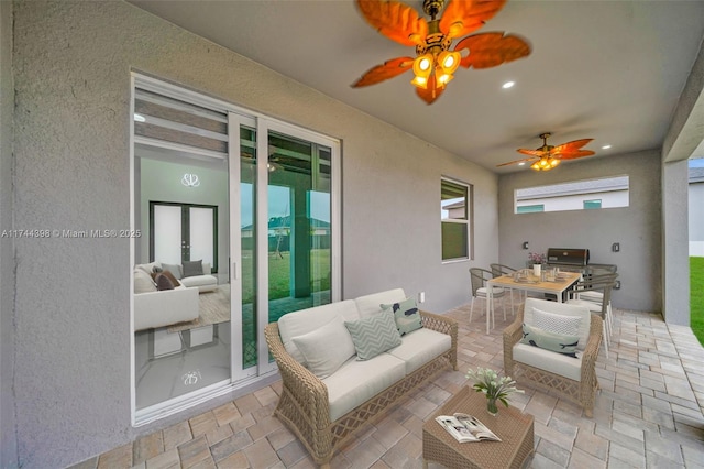 view of patio / terrace with an outdoor living space, french doors, and ceiling fan