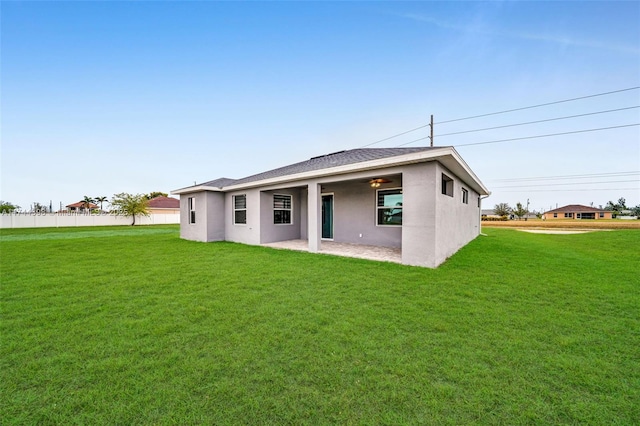 back of house featuring a yard