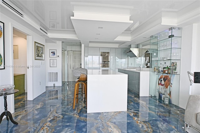 interior space with marble finish floor, modern cabinets, visible vents, and light countertops