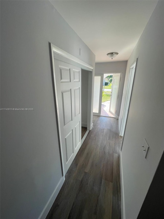 corridor with dark hardwood / wood-style floors