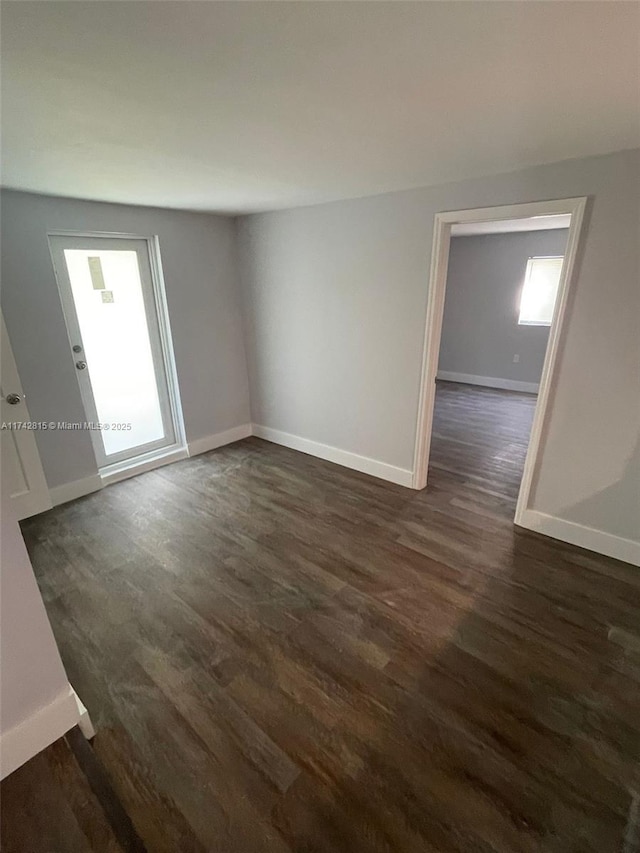 spare room with dark hardwood / wood-style flooring