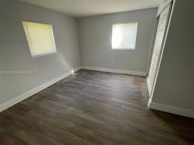 spare room featuring dark wood-type flooring