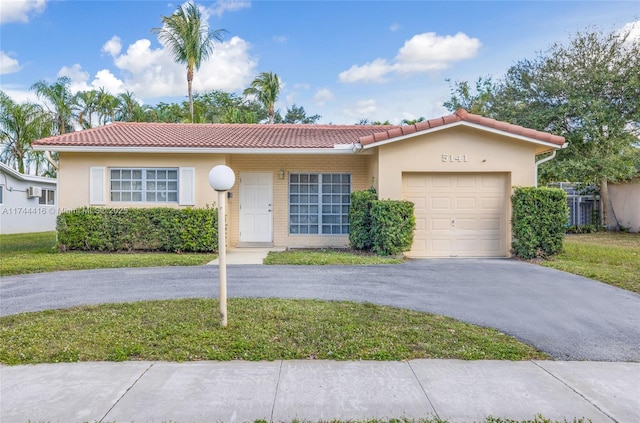 view of front of home featuring a garage and a front lawn