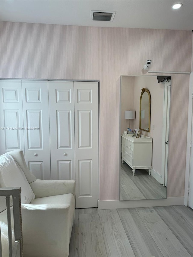 interior space with light hardwood / wood-style flooring and a closet