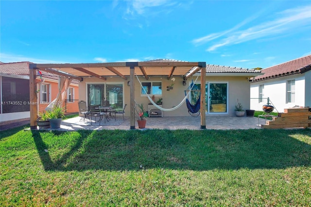 rear view of house featuring a pergola, a lawn, and a patio area