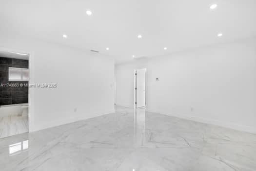 interior space with recessed lighting and marble finish floor