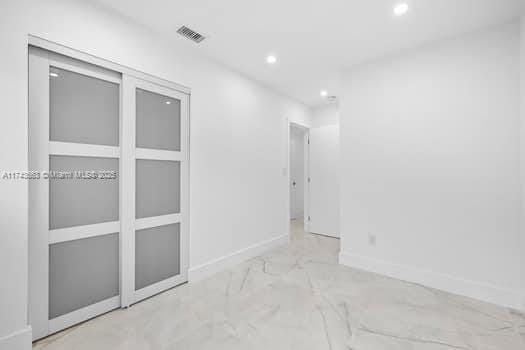 1431-1433 N 14th Way, Hollywood, FL 33020 - empty room featuring recessed lighting and marble finish flooring