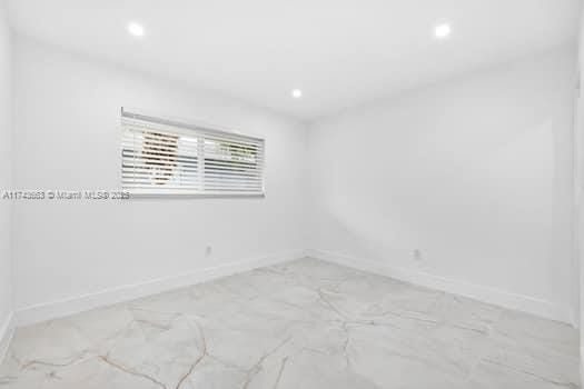1431-1433 N 14th Way, Hollywood, FL 33020 - spare room with recessed lighting and light marble finish flooring