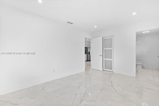 1431-1433 N 14th Way, Hollywood, FL 33020 - unfurnished room with light marble finish floors and recessed lighting