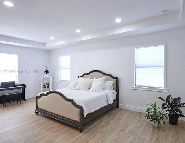 bedroom with light wood finished floors, baseboards, and recessed lighting