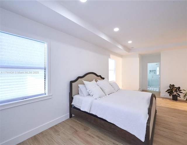 bedroom featuring light wood-style flooring, baseboards, ensuite bathroom, and recessed lighting